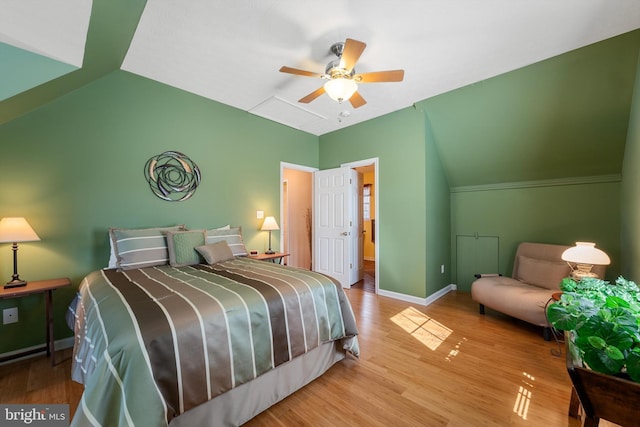 bedroom featuring ceiling fan, baseboards, vaulted ceiling, and wood finished floors