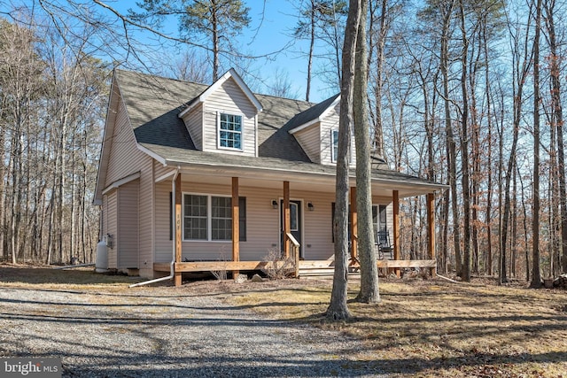 view of front of home featuring covered porch and roof with shingles