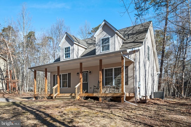 view of front of home featuring a shingled roof, covered porch, and central AC unit