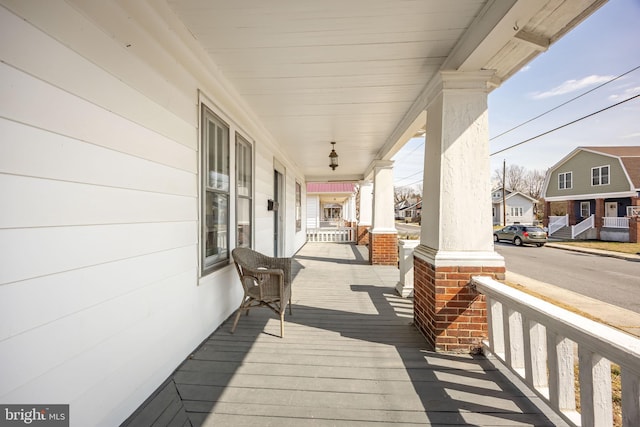 deck featuring a residential view and covered porch