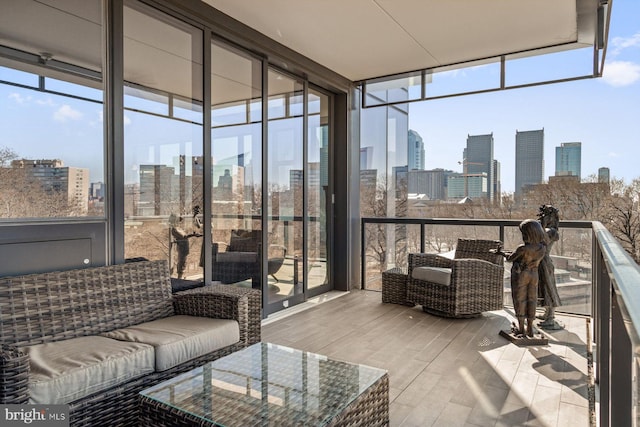 sunroom featuring a city view