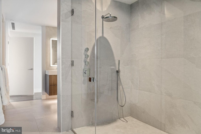 full bathroom with a shower stall, visible vents, and vanity