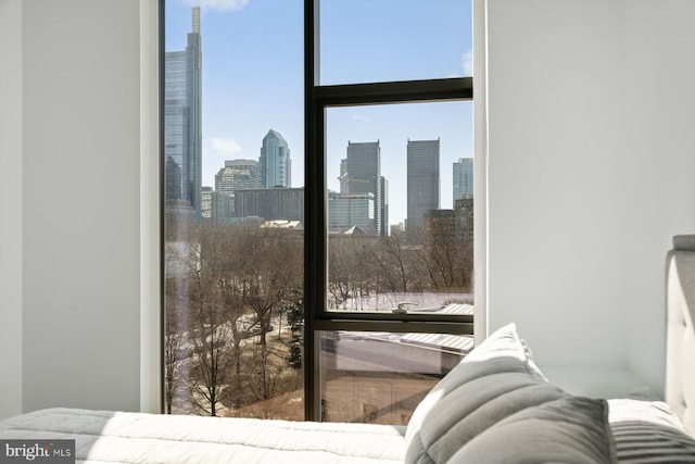 interior space featuring multiple windows, a wall of windows, and a city view