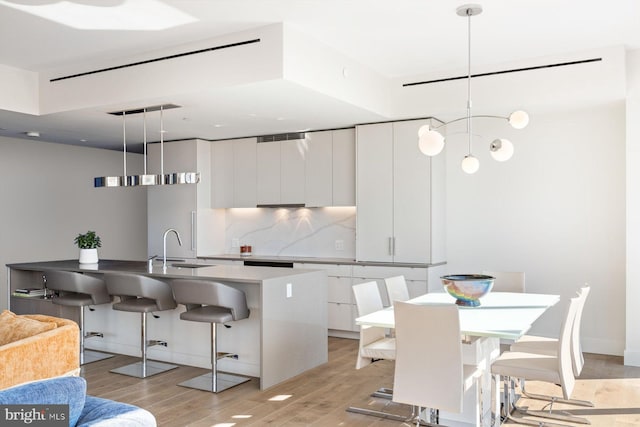 kitchen featuring white cabinets, decorative light fixtures, and modern cabinets