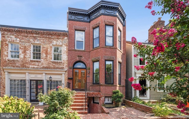 view of front of property with french doors and brick siding