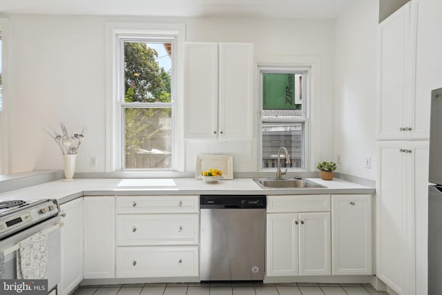 kitchen with a sink, stainless steel appliances, and white cabinetry