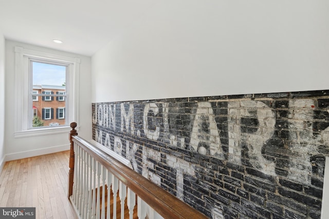 hall featuring an upstairs landing, recessed lighting, light wood-style flooring, and baseboards