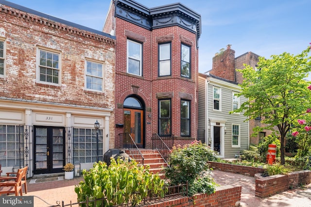 view of front of property featuring french doors and brick siding