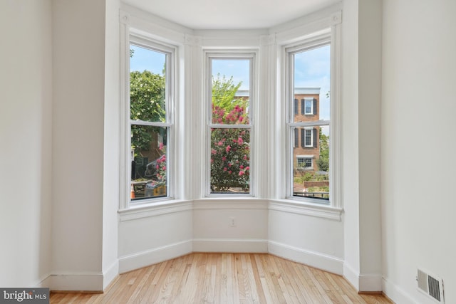 interior space featuring visible vents, baseboards, and wood finished floors