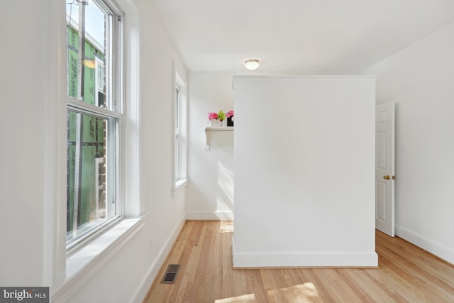 unfurnished bedroom with visible vents, baseboards, and light wood finished floors