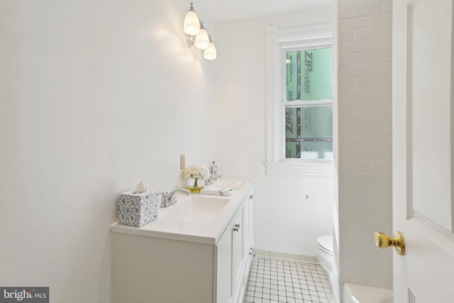 full bath with tile patterned floors, toilet, double vanity, and a sink