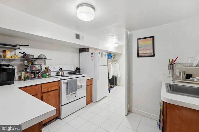 kitchen with brown cabinetry, white appliances, and light countertops