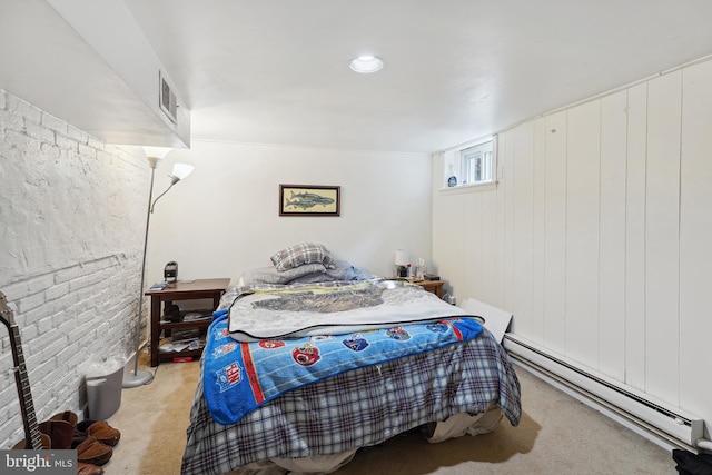 bedroom with visible vents, light colored carpet, and a baseboard heating unit