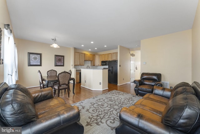 living room with baseboards, dark wood-type flooring, and recessed lighting