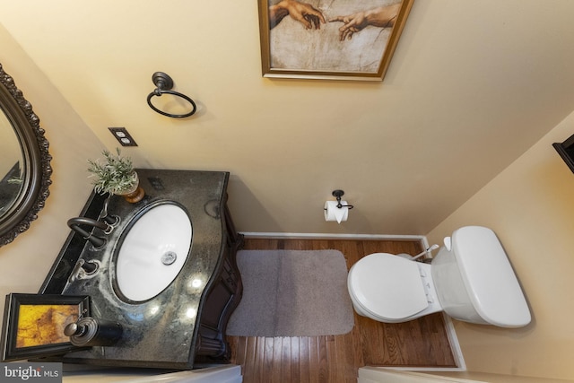 half bathroom featuring toilet and wood finished floors