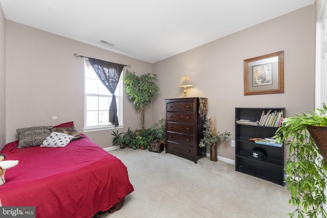 carpeted bedroom featuring visible vents and baseboards