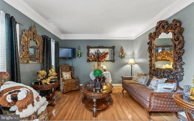 sitting room with wood finished floors and crown molding