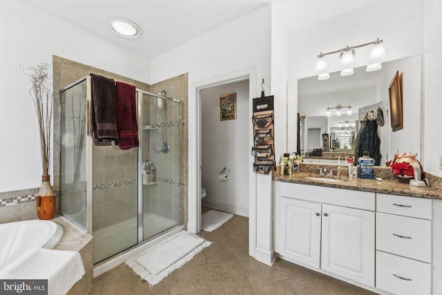 full bath with a garden tub, toilet, vanity, a shower stall, and tile patterned floors