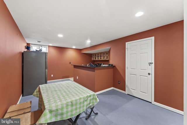 interior space with baseboards, indoor bar, concrete flooring, and recessed lighting