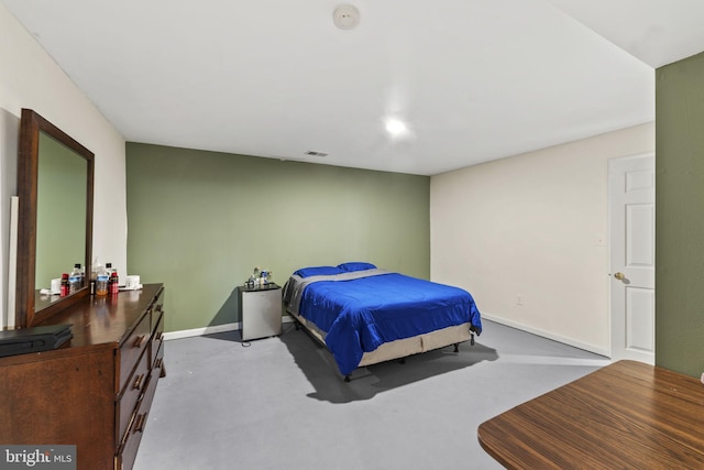 bedroom featuring baseboards and visible vents