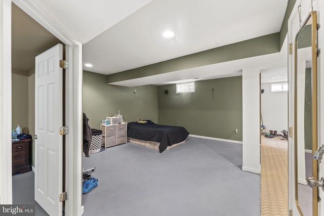 bedroom featuring recessed lighting, finished concrete floors, and baseboards