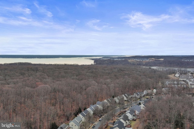 bird's eye view with a water view and a forest view