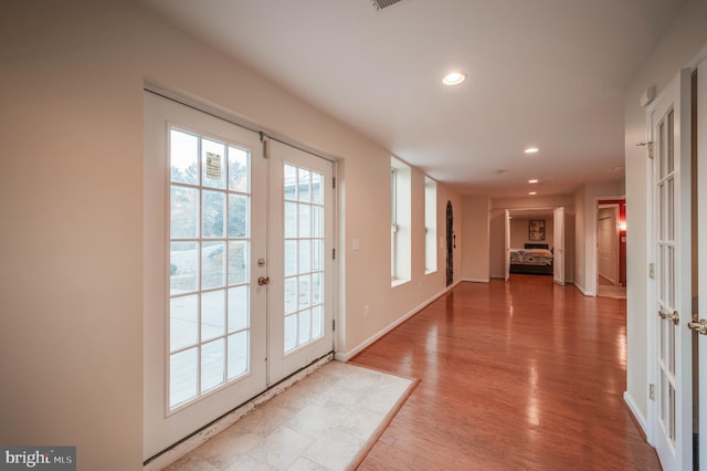 entryway with recessed lighting, baseboards, wood finished floors, and french doors