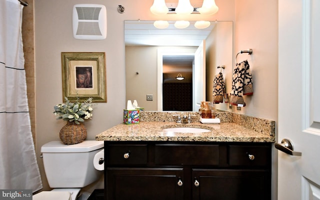 full bathroom featuring toilet and vanity