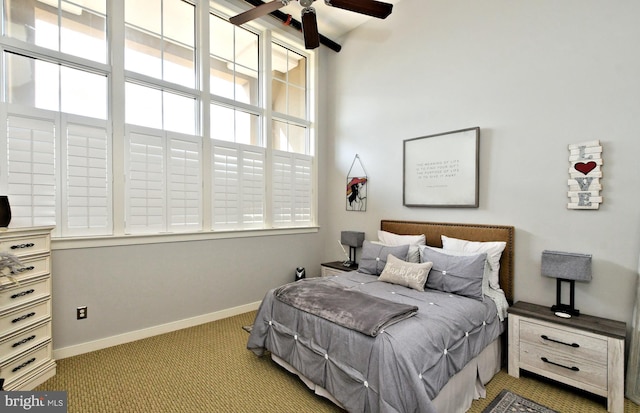 carpeted bedroom featuring baseboards