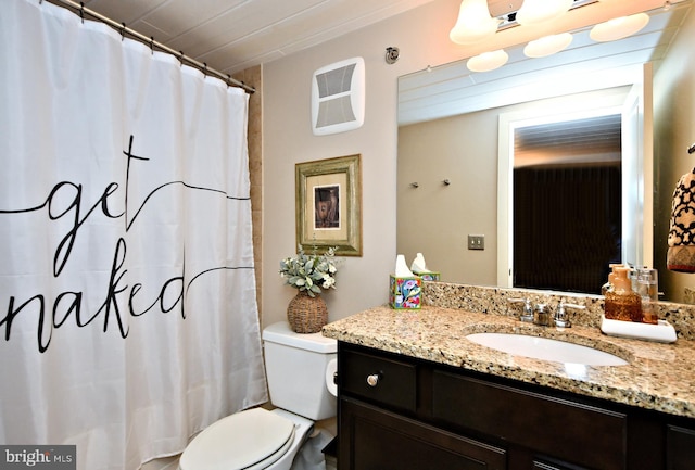 bathroom featuring toilet, a shower with shower curtain, and vanity