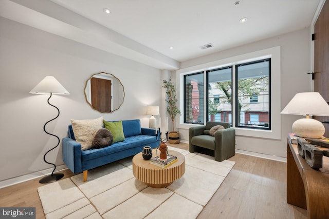 living area featuring recessed lighting, light wood-type flooring, visible vents, and baseboards