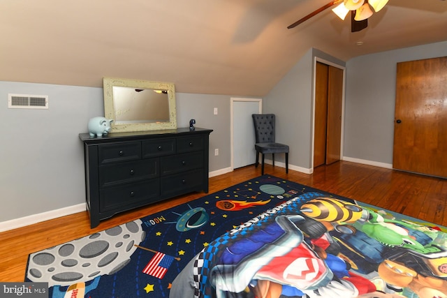 bedroom featuring baseboards, visible vents, lofted ceiling, ceiling fan, and wood finished floors