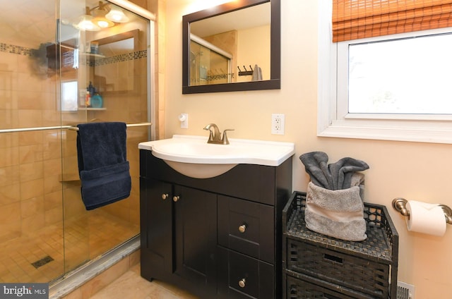 full bath with a stall shower and vanity