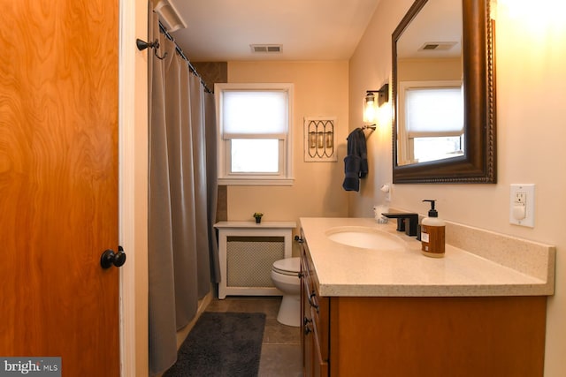 full bath featuring toilet, radiator heating unit, visible vents, and vanity