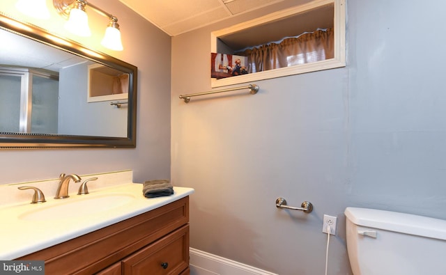 full bathroom with toilet, a shower with shower door, and vanity