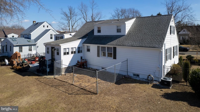 back of property featuring fence, central AC unit, and roof with shingles