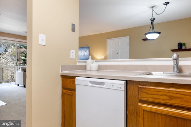 kitchen with carpet, a sink, light countertops, dishwasher, and brown cabinets