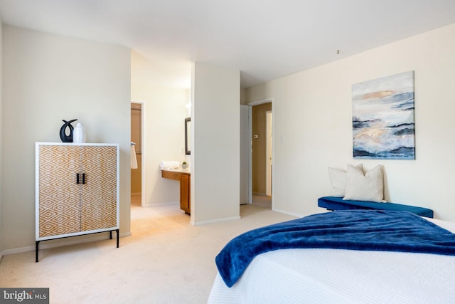 bedroom with baseboards and light carpet