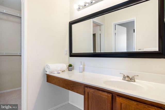 bathroom with vanity and baseboards