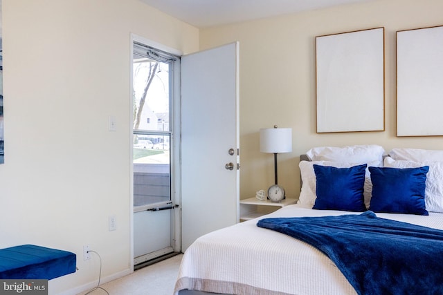 bedroom with baseboards and light carpet