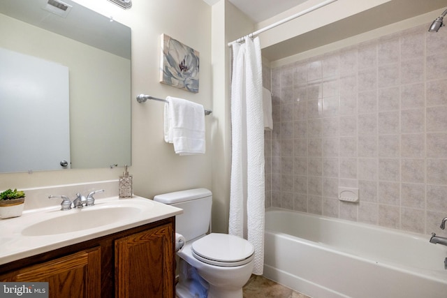 bathroom with vanity, toilet, shower / bath combo, and visible vents