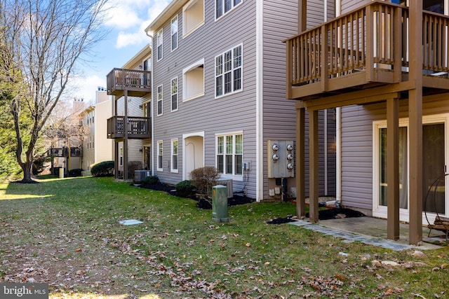 view of side of home with a yard and central AC unit