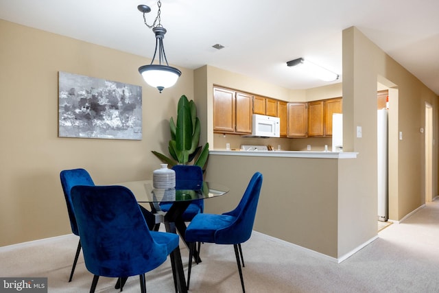 dining area featuring visible vents, baseboards, and light carpet