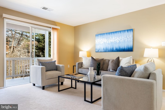 living room with visible vents and light carpet