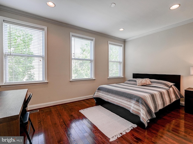 bedroom with ornamental molding, multiple windows, baseboards, and hardwood / wood-style flooring