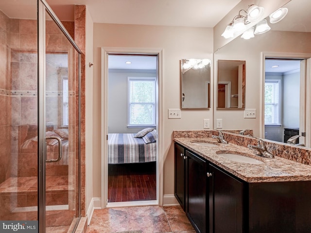 bathroom featuring a sink, ensuite bath, and a wealth of natural light