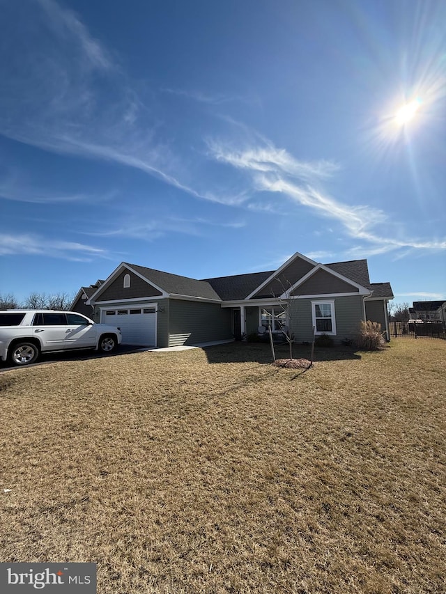 single story home featuring a garage and a front lawn