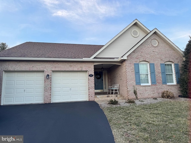 single story home with aphalt driveway, brick siding, a shingled roof, and a garage