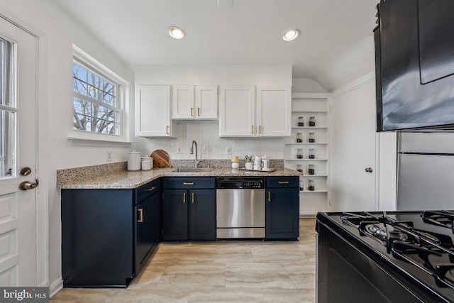 kitchen featuring white cabinets, dishwasher, blue cabinets, a sink, and gas stove