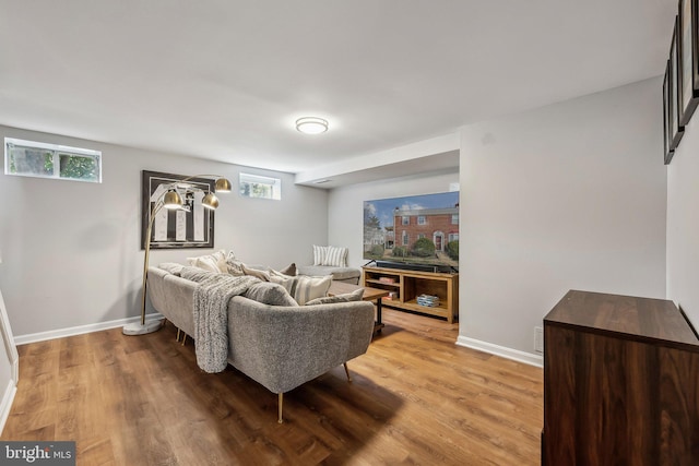 living room featuring light wood-type flooring and baseboards